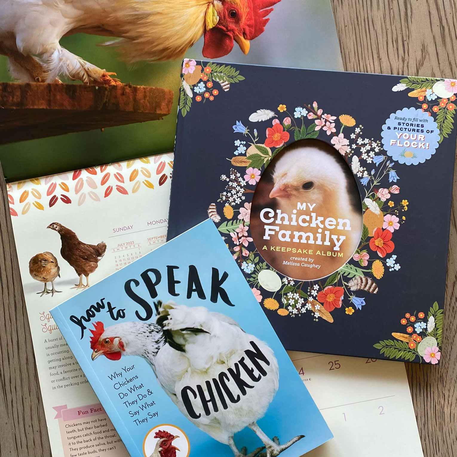 Photo of My Chicken Family book, How to Speak Chicken book, and wall calendar.