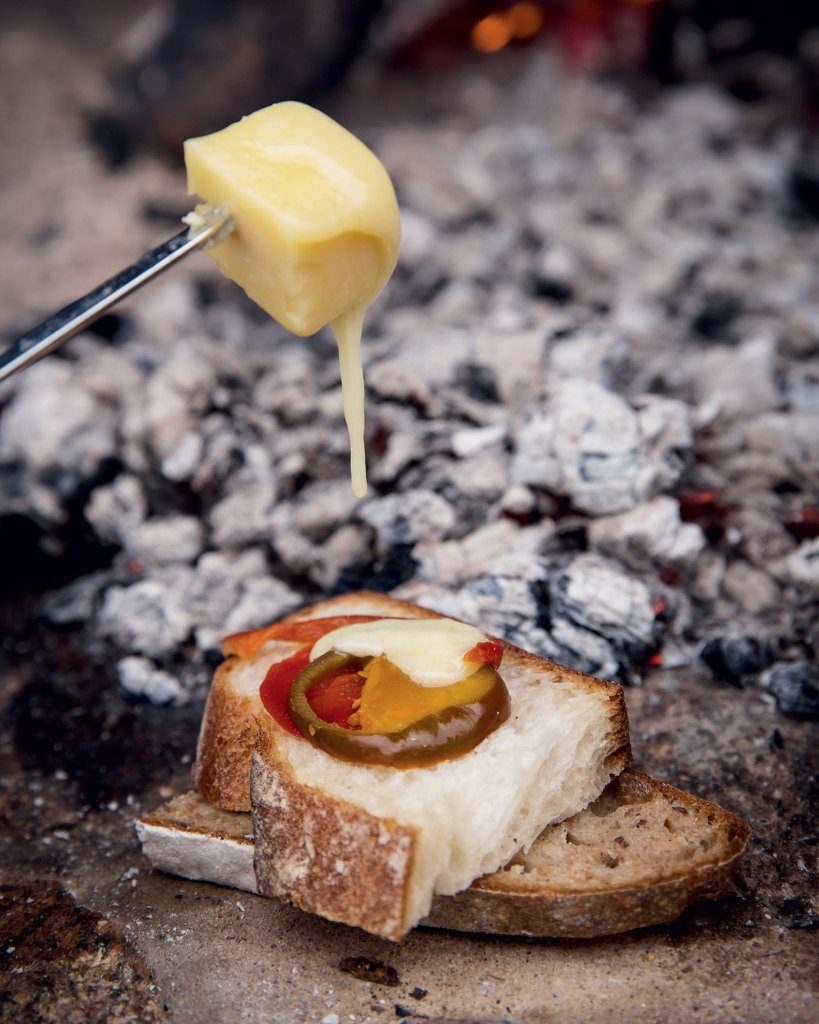 Photo of toasted cheese on a stick with bread.