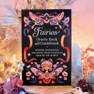 Photo of the Fairies Oracle Deck and Guidebook surrounded by crystals and natural decor