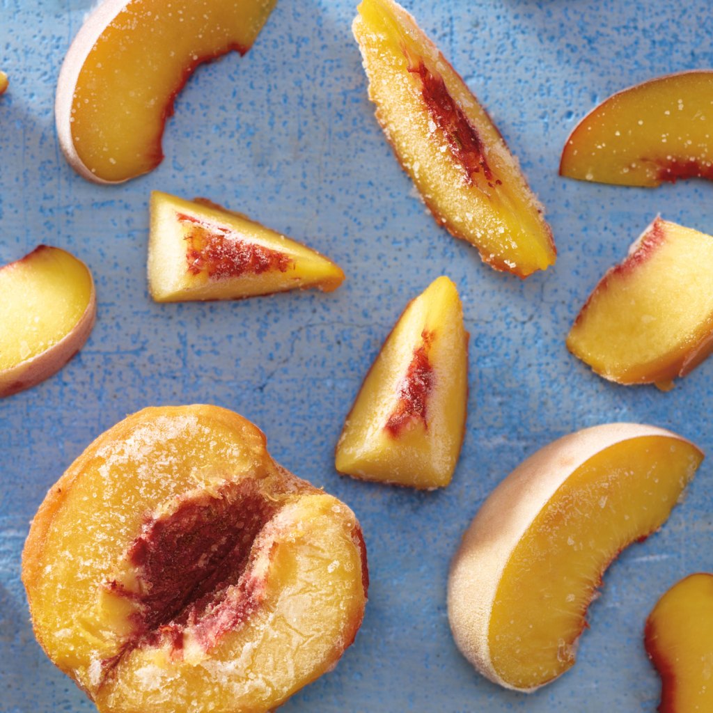 A photo of delicious looking frozen peach slices.