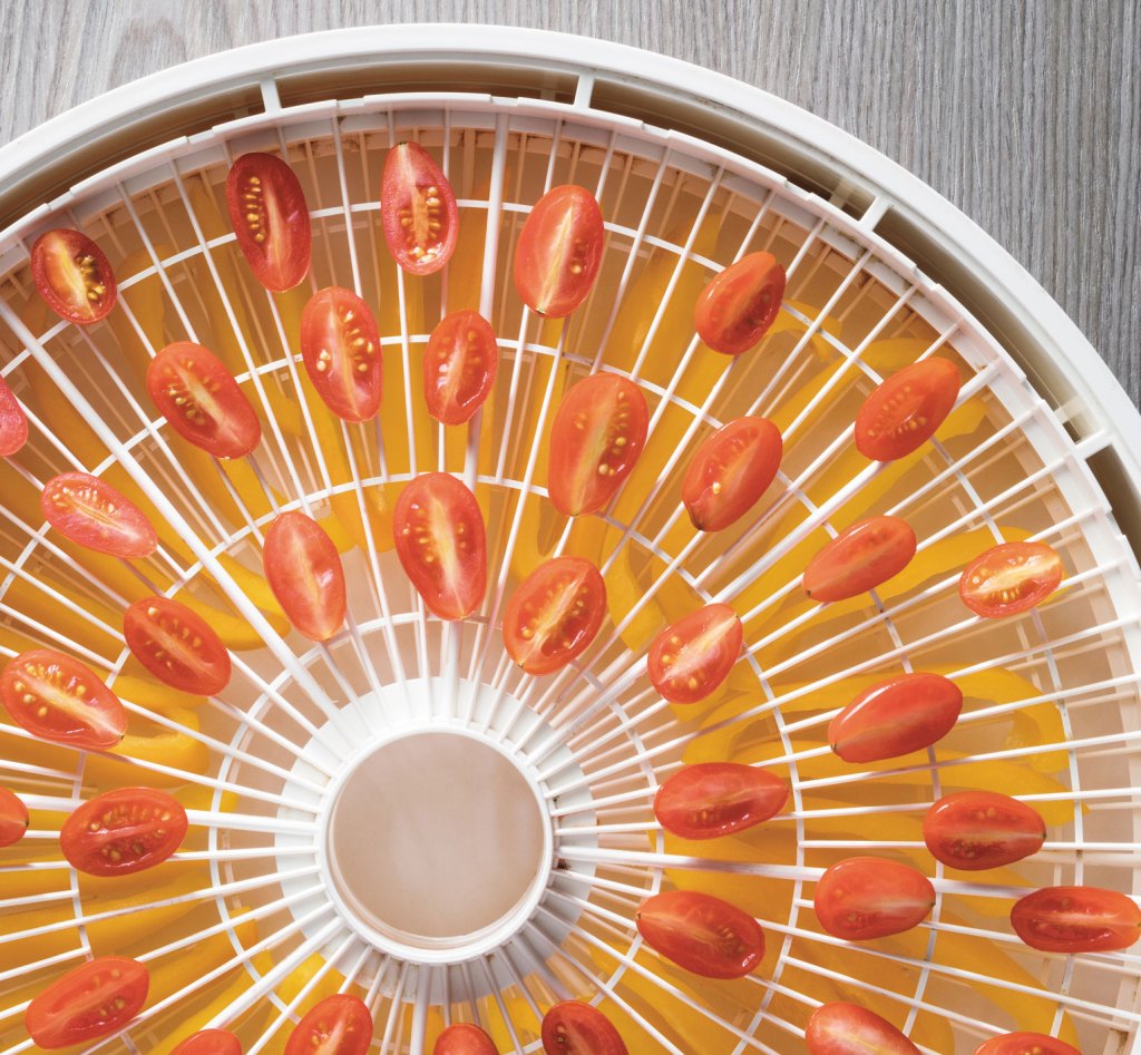 Photo of cherry tomatoes in a dehydrator.