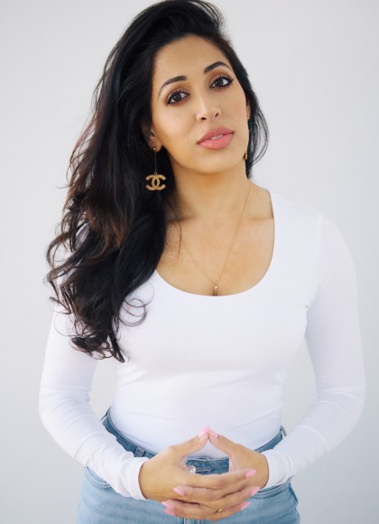 Author photo of Dr. Seema Yasmin wearing a white shirt and clasping hands