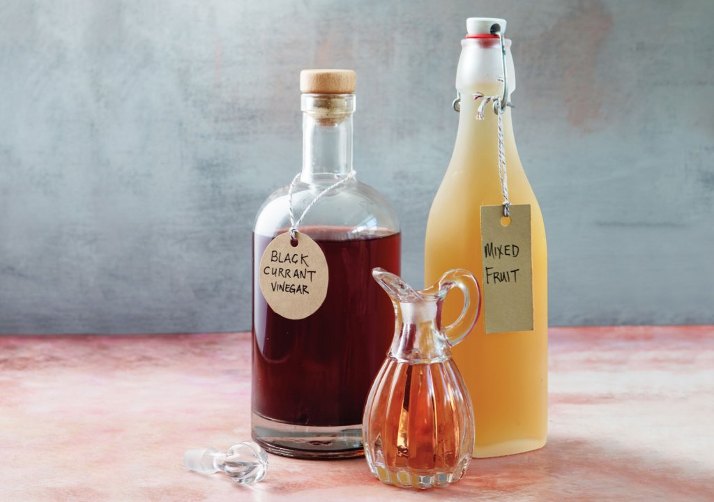 Photo of three bottles of homebrewed vinegar.