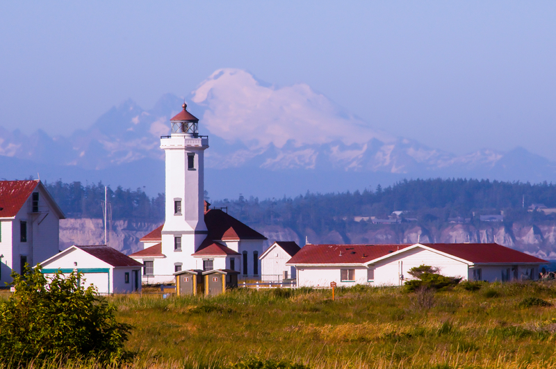 Lighthouse at Fort Worden State Park, Washington with mountain range in the background