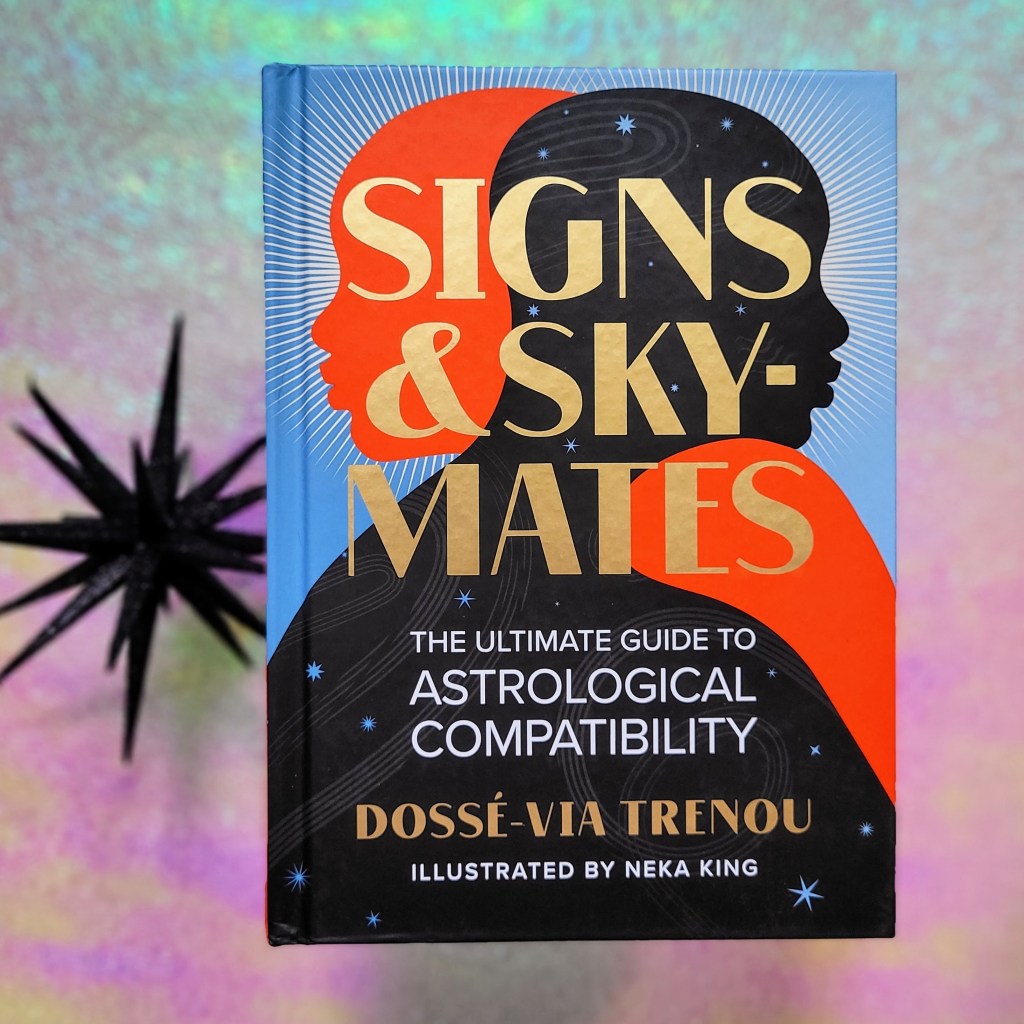 Photo of "Signs & Skymates" laid next to a black decorative starburst against a pink and green iridescent background