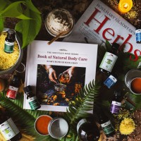 Mountain Rose Herbs Book of Body care surrounded by products from Mountain Rose Herbs and the Rosemary Gladstar Herb Calendar for 2024