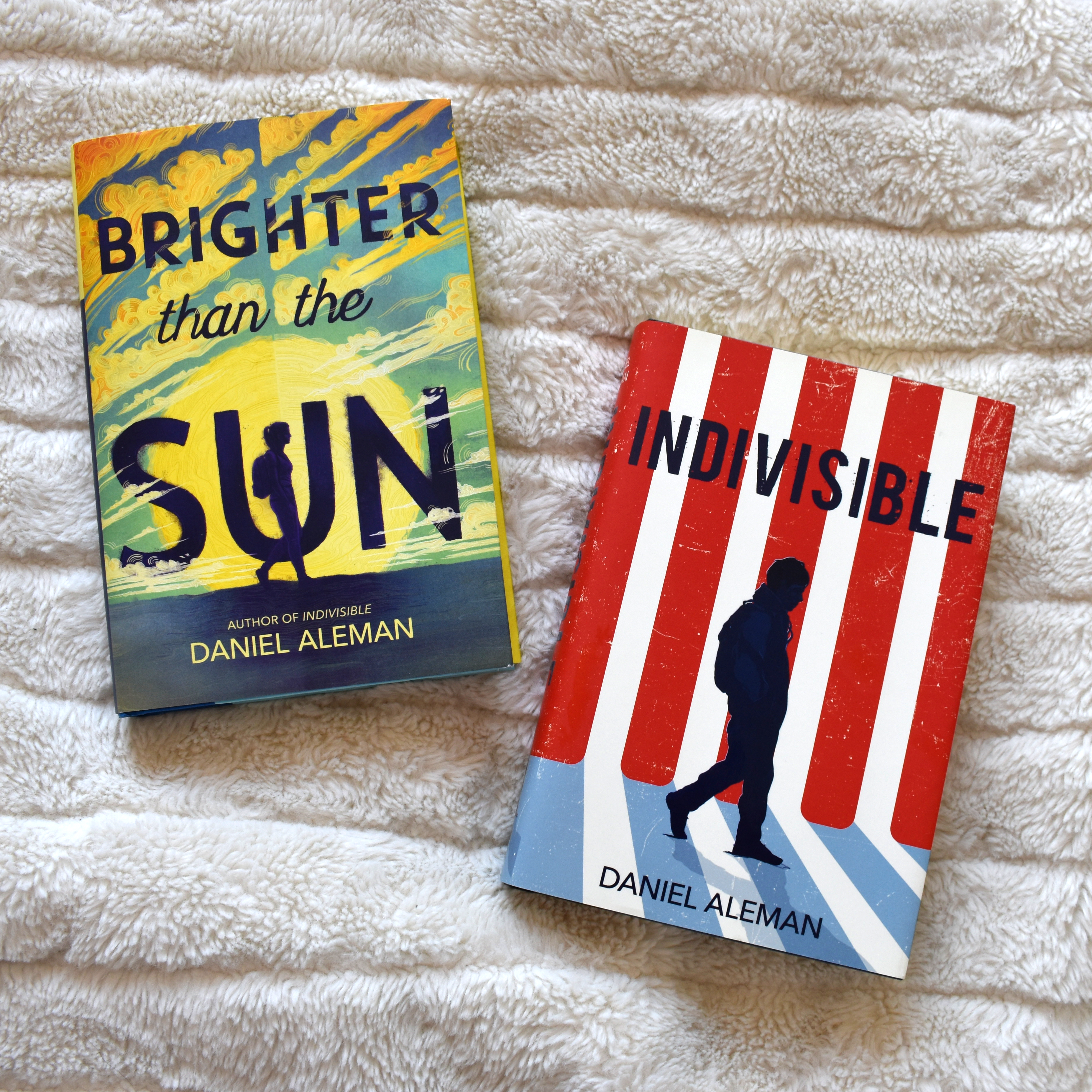 Instagram image of the books "Brighter than the Sun" and "Indivisible" by Daniel Aleman