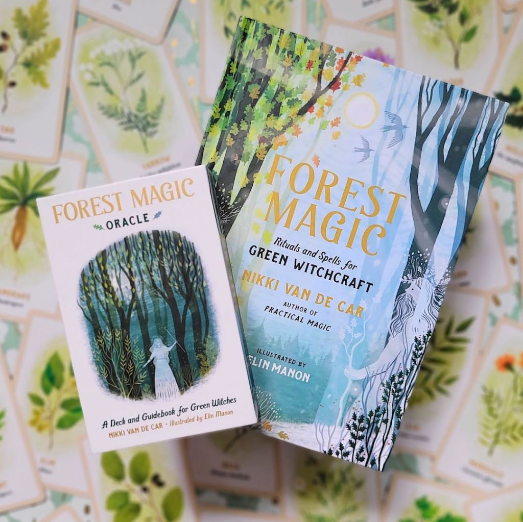 Photo of the hardcover “Forest Magic” and the “Forest Magic Oracle” laid above face-up cards from the deck