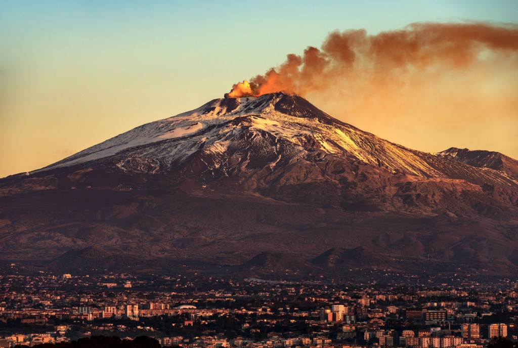 Smoke unfurling from the top of Mount Etna