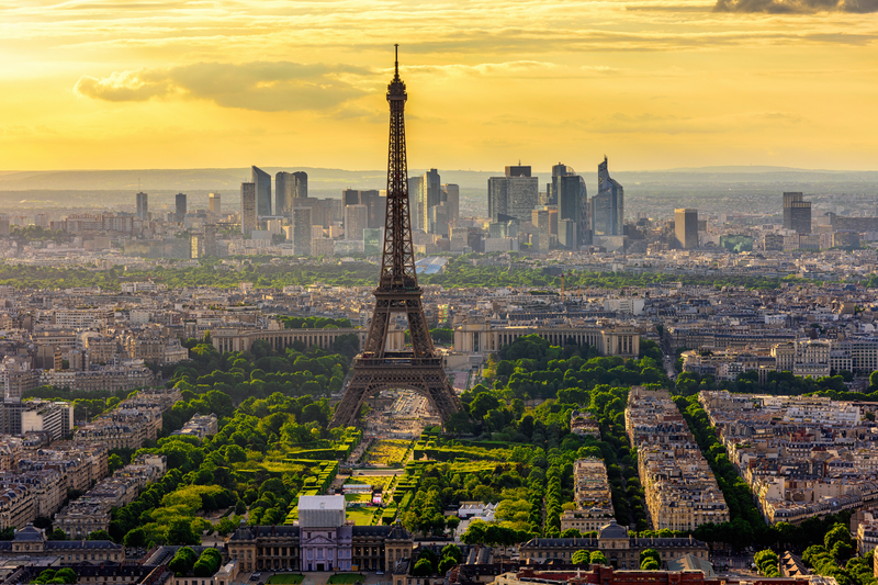 Aerial view of Paris skyline featuring Eiffel Tower at sunset