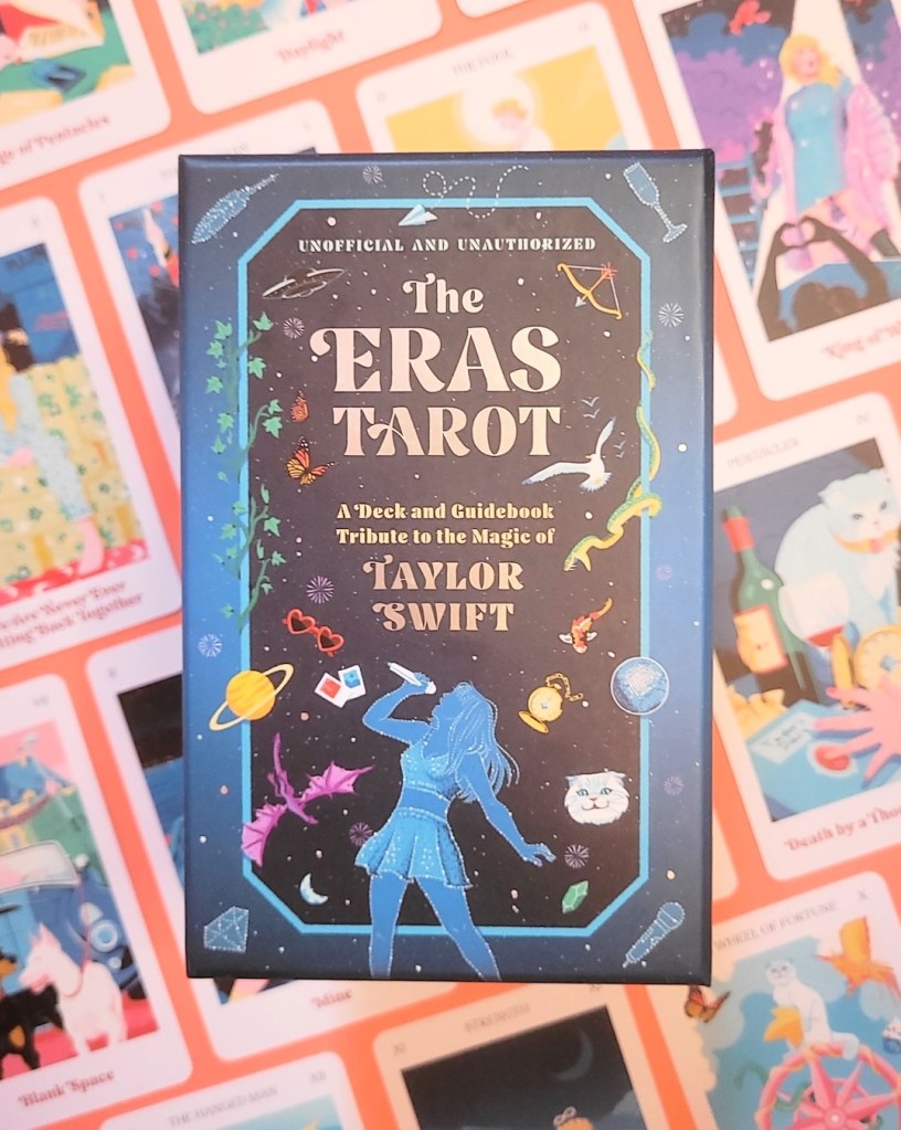 Photo of The Eras Tarot box above cards from the deck