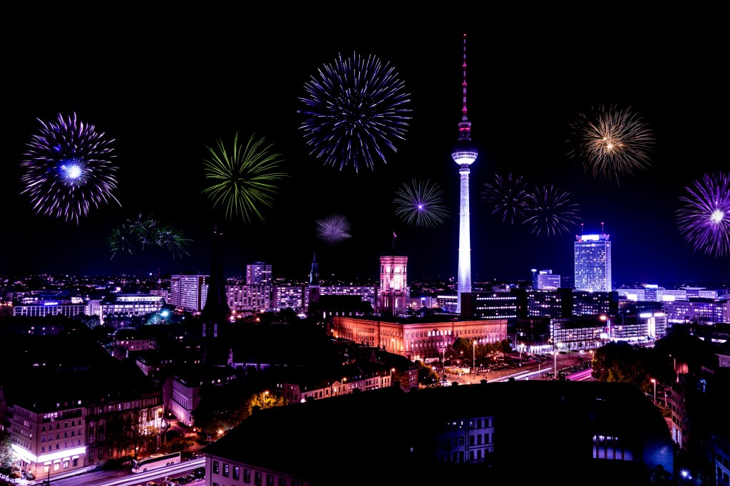 Fireworks behind the Berlin TV Tower at nighttime.