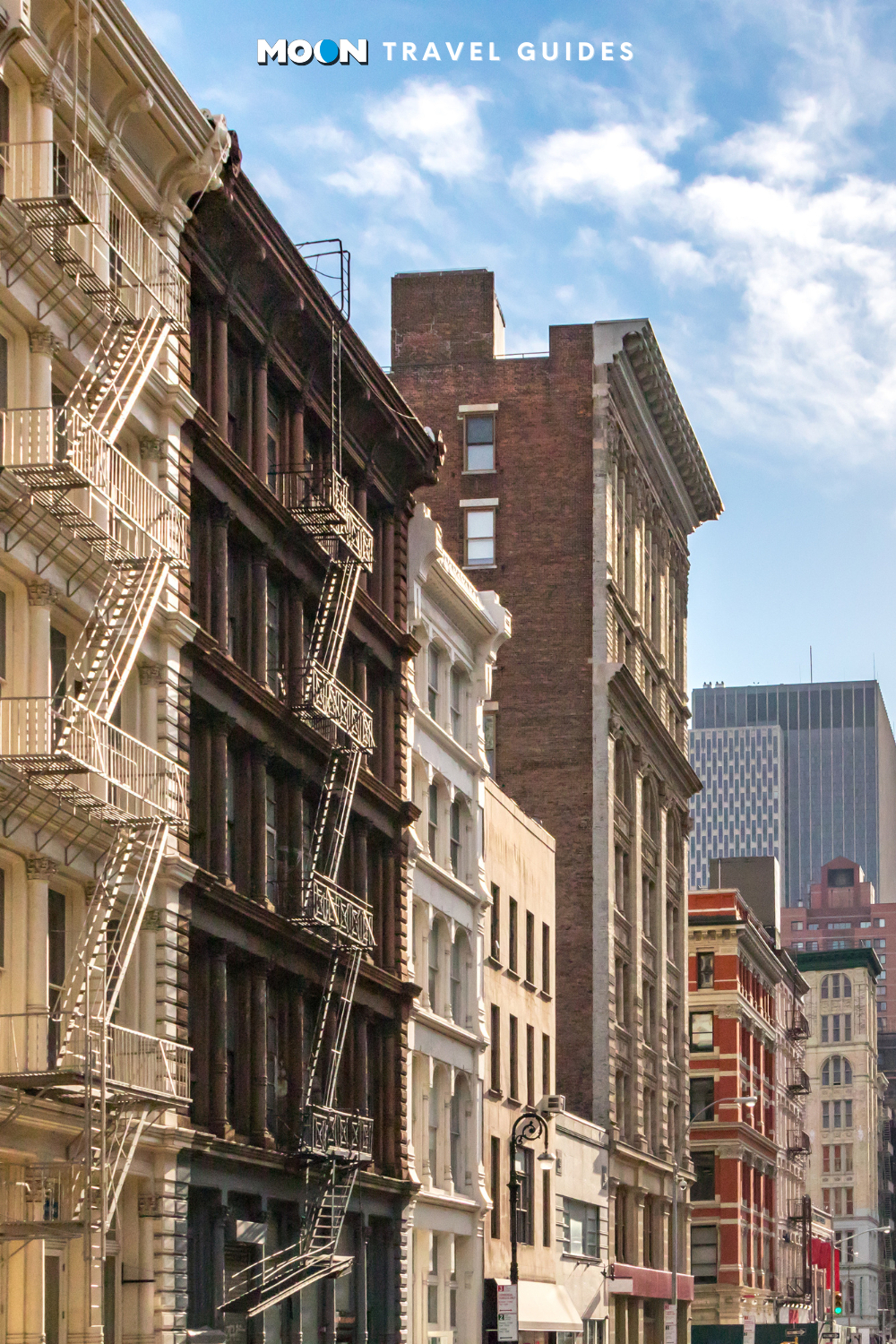 image of old brick row houses with fire escape ladders on a sunny new york street and the moon logo at the top
