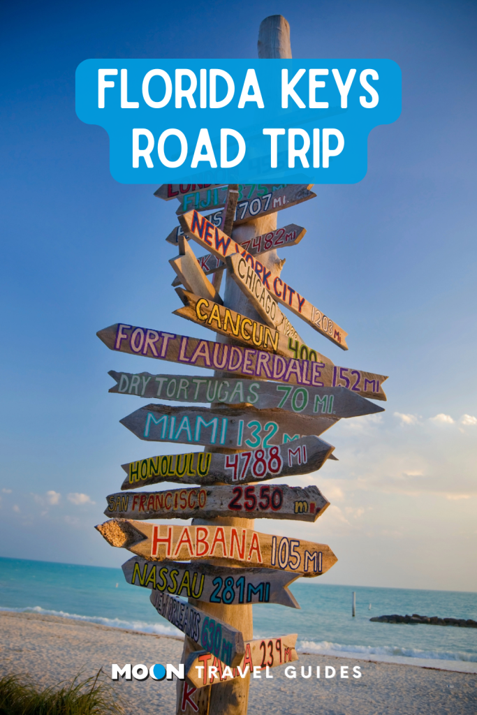 a colorful wooden sign on the beach in key west, with header text of article title