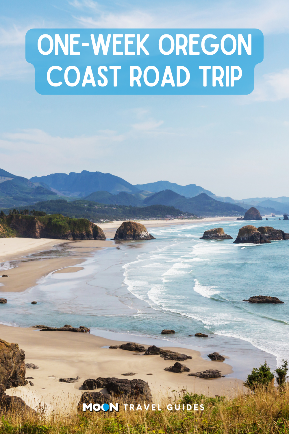 for pinterest: wide sandy beach with large rock formations throughout the rolling waves