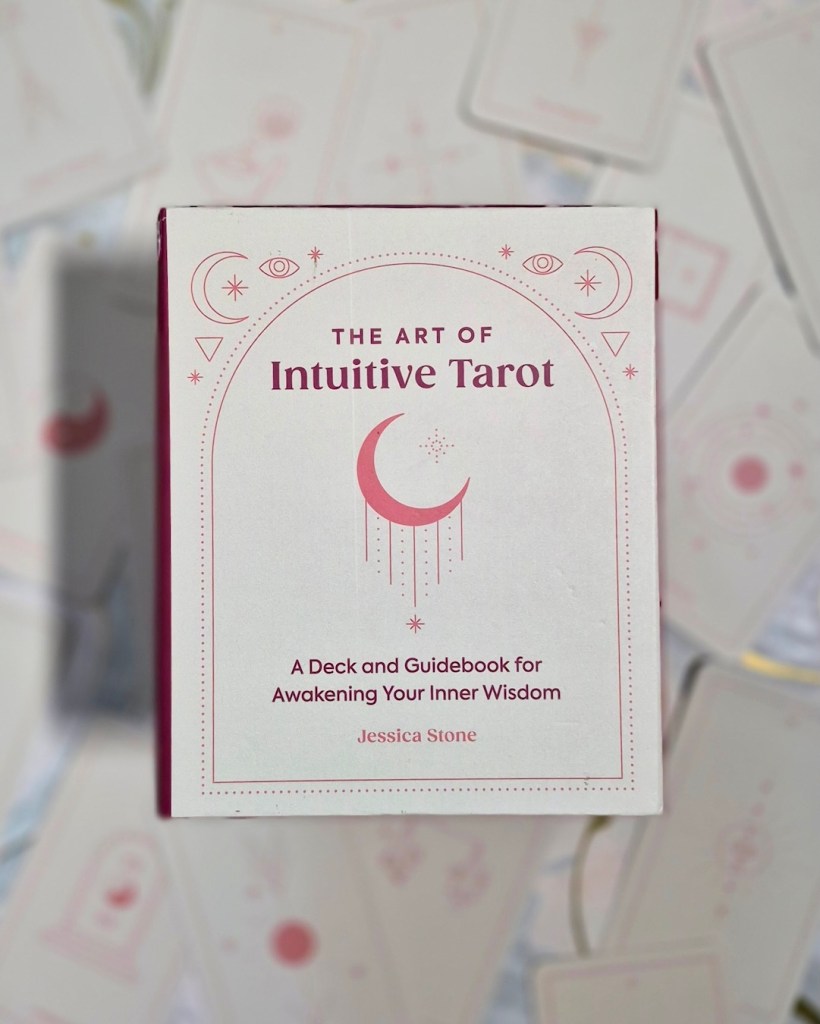 Photo of The Art of Intuitive Tarot box laid above cards from the deck