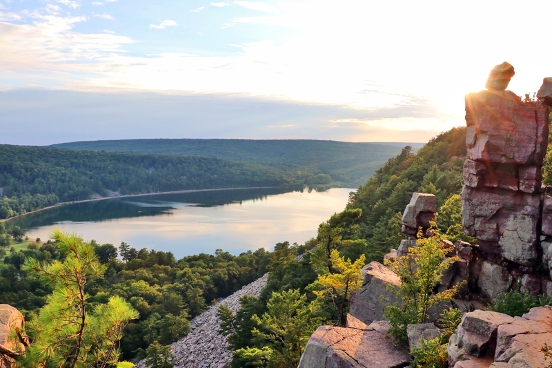 a cliff slide overlook of a mirrored late surrounded by pine trees