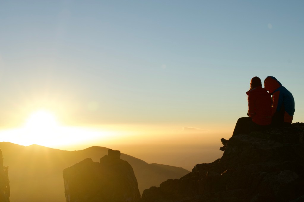 A couple on a mountaintop after a hike