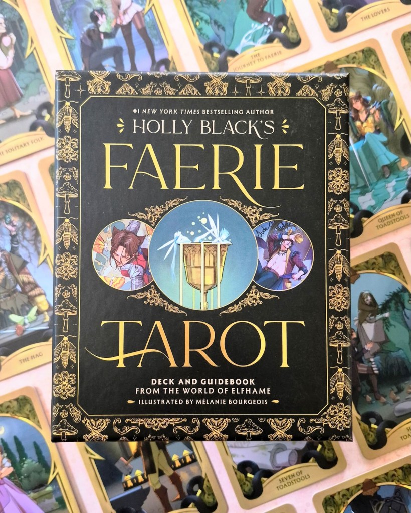 Photo of the box of Holly Black's Faerie Tarot laid above cards from the deck