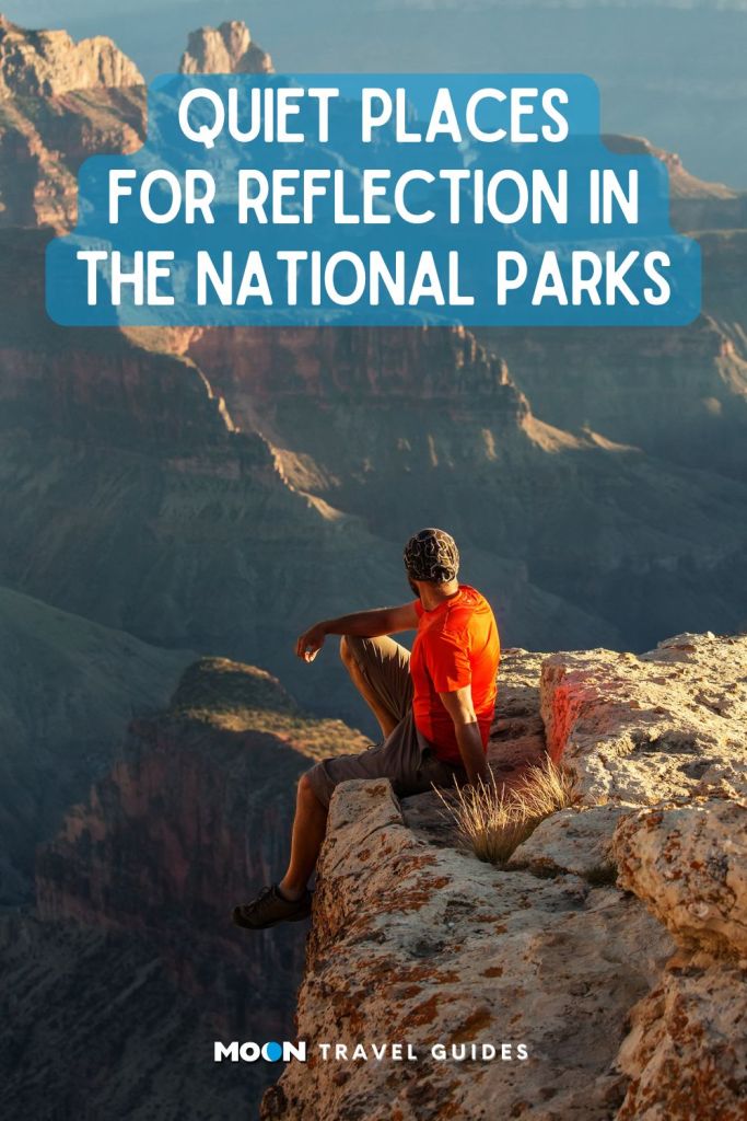 Hiker sitting on a rock high above the Grand Canyon