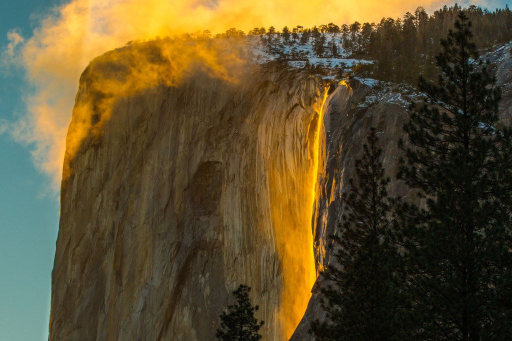 glowing light on a waterfall appears to look like a river of flames running down the mountain