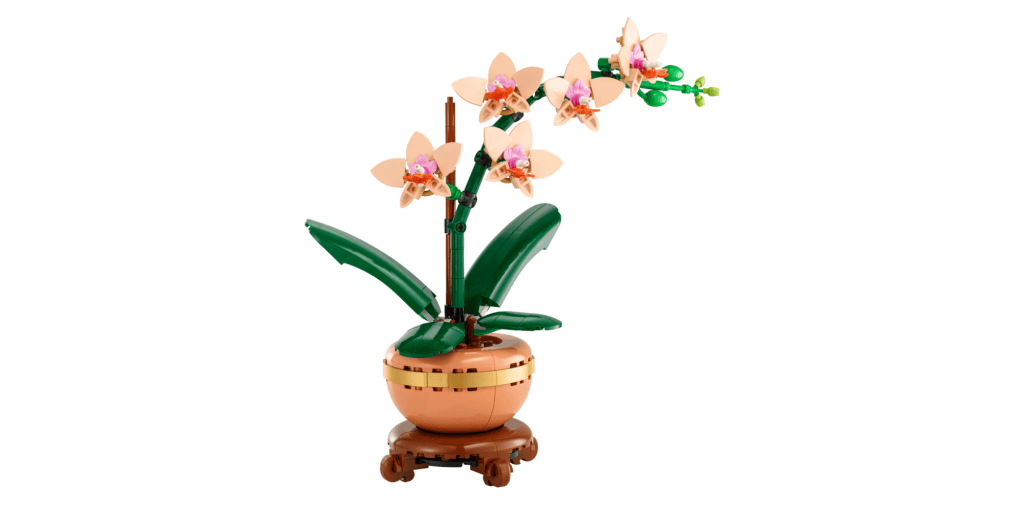 a light pink orchid made out of legos with a small attached pot