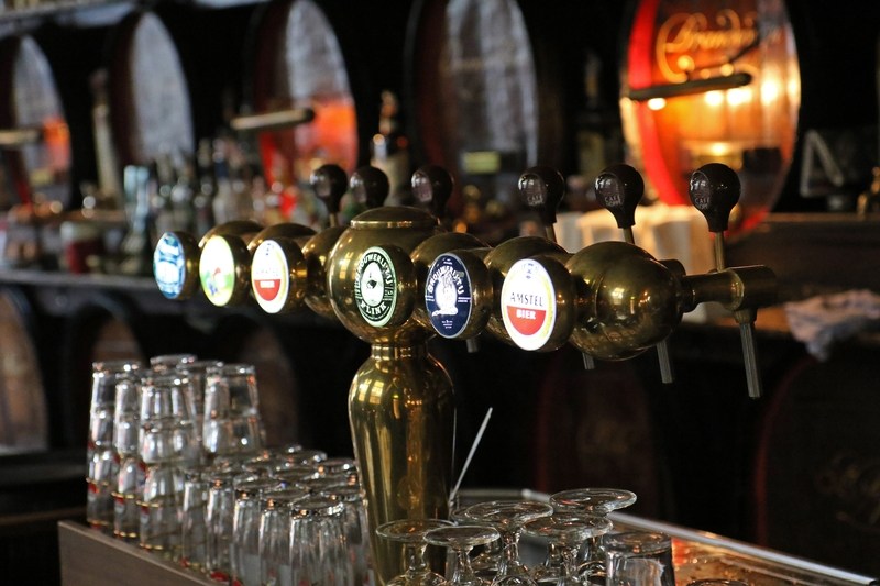 A row of taps at a bar counter